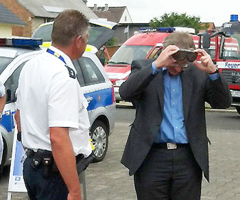 Bürgermeister Wengorsch beim Aufsetzen der Rauschbrille, beobachtet von POK Steffen Dapper